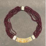 A beautiful Chinese carved russet jade, 925 silver and garnet necklace.