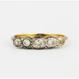 An 18ct yellow gold ring set with graduated old cut diamonds, (P).