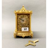 A lovely gilt bronze and mother of pearl dial mantel clock, with elephant head decoration, H. 18cm.