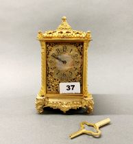 A lovely gilt bronze and mother of pearl dial mantel clock, with elephant head decoration, H. 18cm.