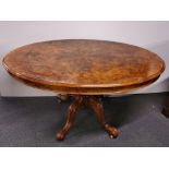 A burr walnut and carved mahogany dining table on castors, H. 73cm 141 x 107cm.