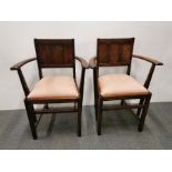 A pair of Victorian panel back carver dining chairs, H. 93cm.