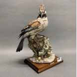 A large resin figure of a Jay on a wooden base after R. Pennati, H. 36cm.