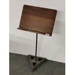 An adjustable cast iron and oak music stand from 'Leigh-On-Sea B.M.G Club' H. 88cm, W. 41cm.