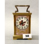 A French gilt brass and porcelain carriage clock, H. 15cm.