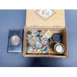 A cigar box of mixed coins and other items.
