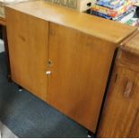 An interesting light oak, metal legged cabinet with drawers inside for filing and a sprung leg for