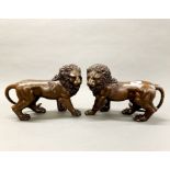 A pair of bronze figures of lions, H 23cm, L. 31cm.