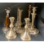 Three pairs of silver plated candlesticks and a pair of chromium plated and oak candlesticks,