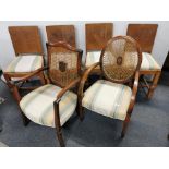 A set of four oak dining chairs together with two cane back carver chairs with matching upholstery.