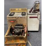 An early toy typewriter, washing machine and cooker, with a red bakelite cream maker. Washing