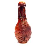 A Chinese reconstituted amber snuff bottle, H. 8cm.