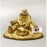 An unusual early 20th century gilt brass figural inkwell, W. 15cm, H. 10cm.