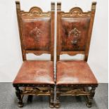 A pair of English carved elm and leather hall chairs, H. 119cm.