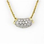A 14ct yellow and white gold pendant set with cubic zirconias on a 9ct yellow gold chain, L. 42cm.