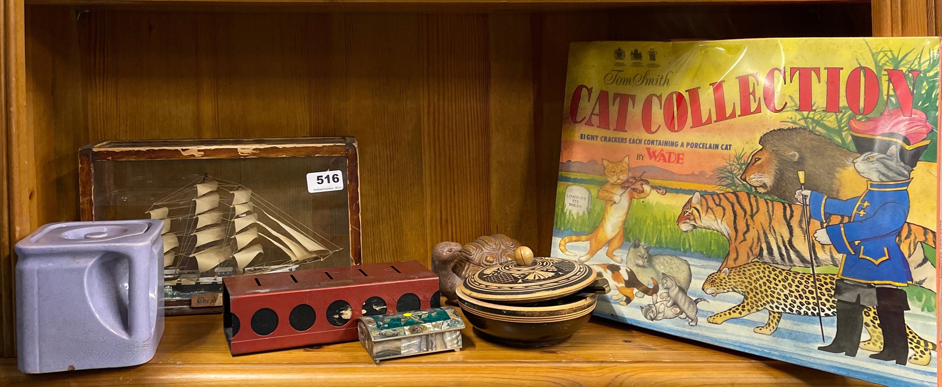A boxed Wade cat collection, a boat in a glass case and other items.