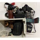 A quantity of mixed cameras and lenses.