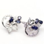 A pair of 925 silver earrings set with oval cut sapphires and white stones, L. 19cm.