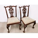 A pair of early 19th century tapestry upholstered ball and claw foot chairs.