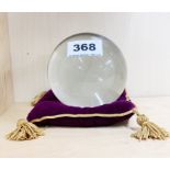 A large crystal ball and cushion with stand, Dia. 10cm.