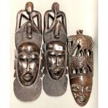 A group of three African carved wooden tribal masks, longest L. 51cm.