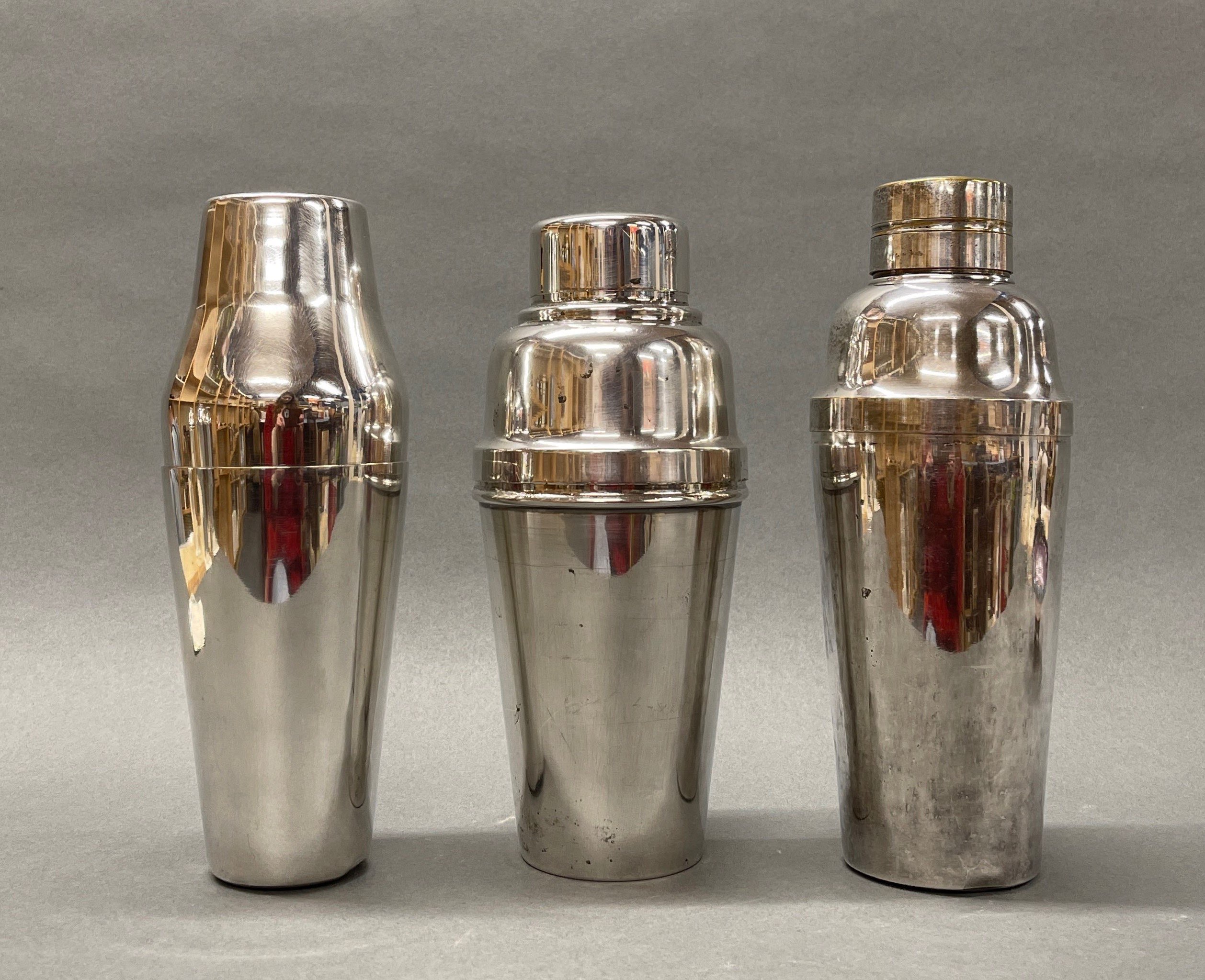 An English Art Deco silver plated cocktail shaker, H. 25cm, together with two further silver