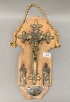 An early 20th century gilt metal crucifix and font, H. 40cm.
