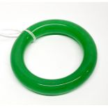 A polished jade bangle, jade W. 1.5cm, internal dia. 5.5cm.