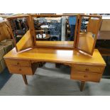 A teak mirror backed four drawer dressing table, 145 x 120 x 42cm.