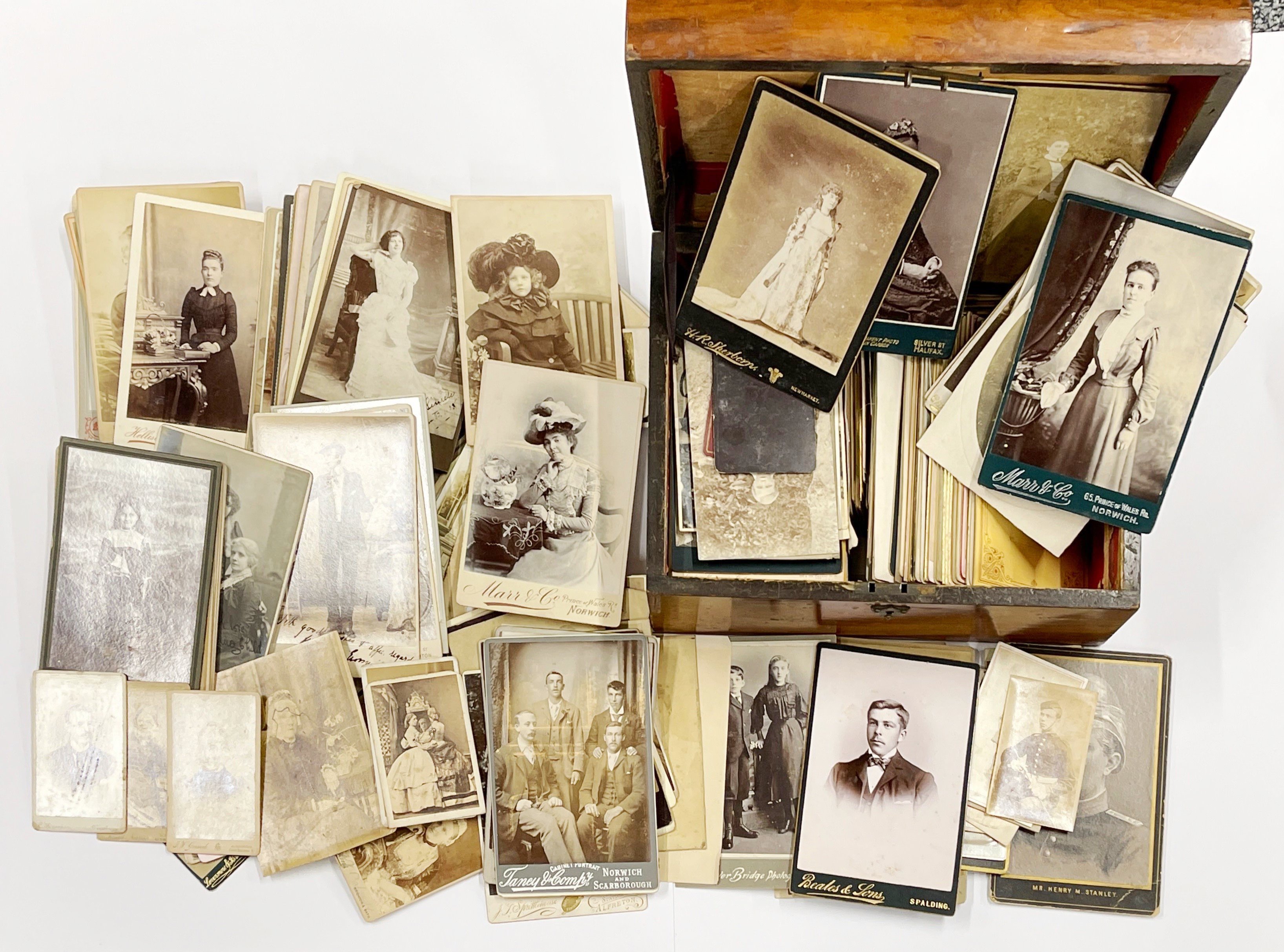 A Victorian workbox, containing a quantity of Victorian photographs and postcards.