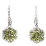A pair of 925 silver drop cluster earrings set with oval cut peridots and white stones, L. 3.9cm.