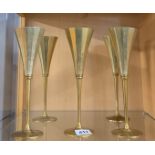 Five unusual mid 20th century brass champagne flutes, H. 24cm.