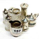 A small Victorian silver cream jug and a group of silver condiment items.