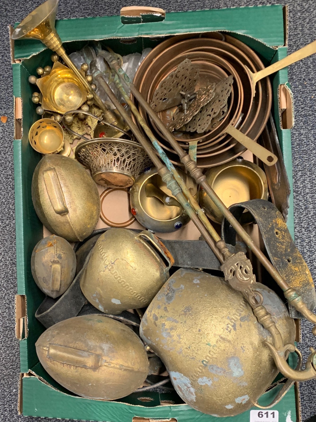 A set of antique cowbells, copper pans etc.