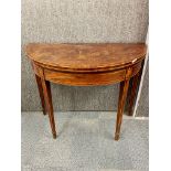 An 18th century inlaid mahogany Demi Lune folding card table, W. 91cm, H. 74cm.