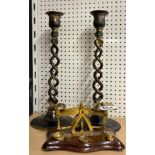 A brass post office scale weights with a pair of silver plated candlesticks.