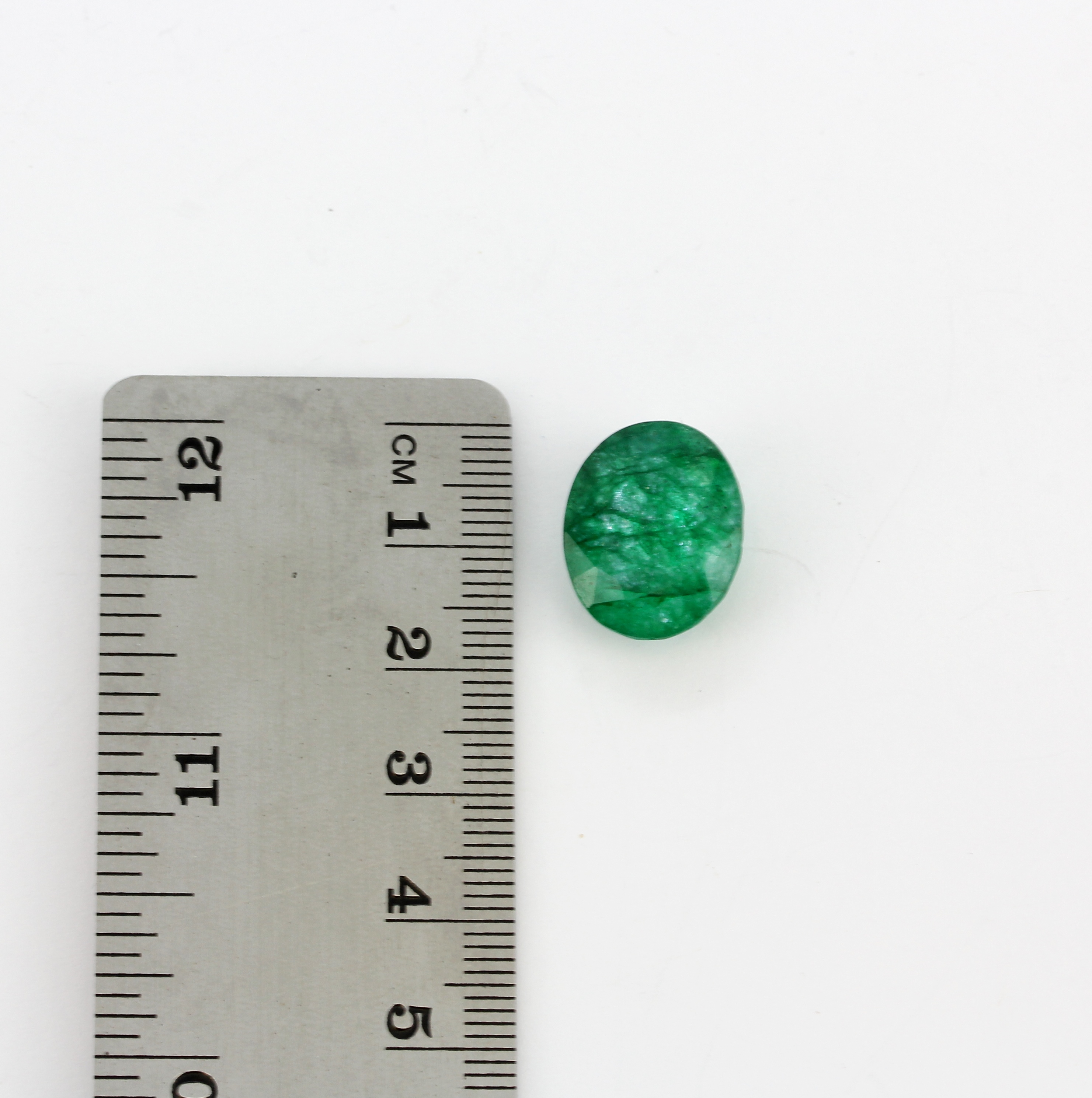 A natural unmounted oval cut emerald, with a certificate, 1.7 x 1.4 x 0.7cm. - Image 2 of 3