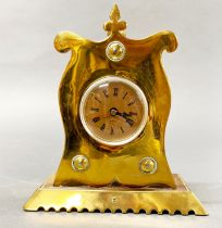 An Arts and Crafts copper and brass mantel clock, with replacement battery movement, H. 19cm.