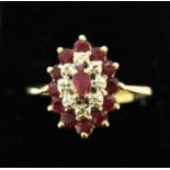 A 9ct yellow gold ruby and diamond set ring, (O) (needs re-shaping).