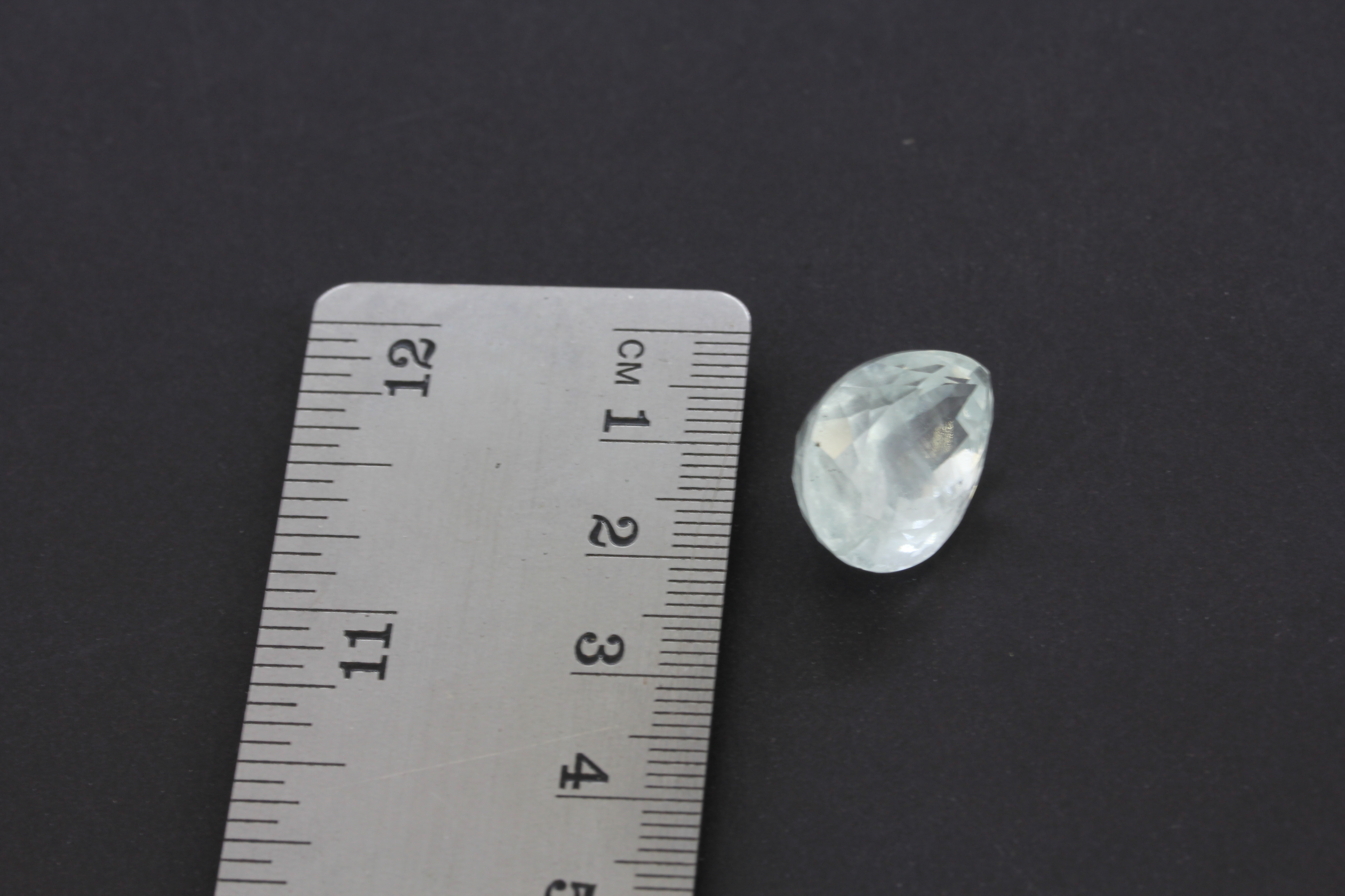 An unmounted pear cut aquamarine with a certificate, 1.9x1.4cm. - Image 2 of 2