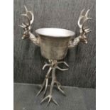 An interesting heavy metal standing champagne bucket /planter with 'antler' legs, H. 107cm W. 64cm.