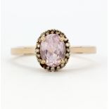 A 9ct rose gold cluster ring set with morganite and diamonds, one diamond missing, with certificate,