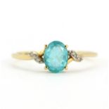 A 9ct yellow gold ring set with an oval cut apatite and diamonds, (T.5).