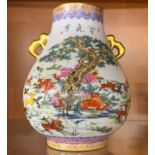 A hand enamelled Chinese porcelain vase, decorated with a herd of deer and with gilt handles, H.