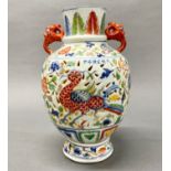 A Chinese pierced hand painted porcelain vase with dragon head handles, H. 33cm.