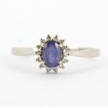 A 9ct white gold tanzanite and diamond set cluster ring, with certificate, (T.5).