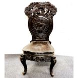 A Burmese lacquered carved wooden chair featuring a tiger, H. 101cm.