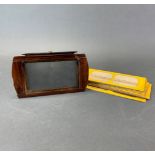 A 19th century mahogany stereo viewer with a group of slides.