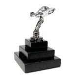 A small chromium plated model of the Spirit of Ecstasy on a granite base, H. 13cm.