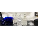 A group of cut crystal decanters and other glassware.
